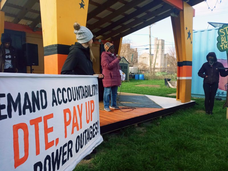 Michelle Jones speaks to a crowd at an energy accountability rally at the Avalon Village community space in Highland Park.