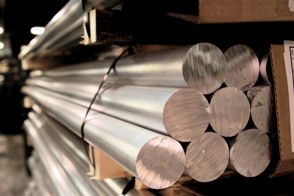 Aluminum rods sit in a stack.