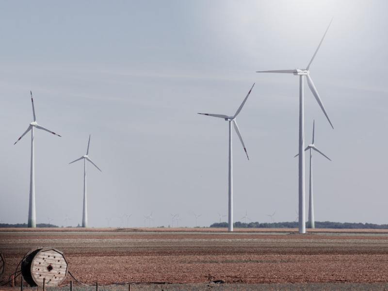 A wind farm in a nondescript rural area.